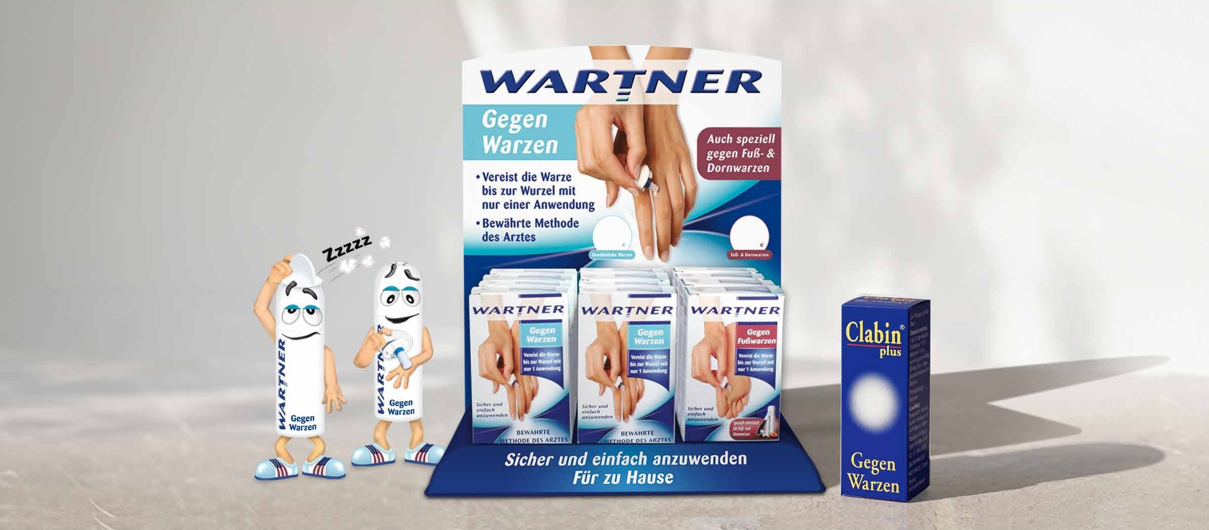 Wartner-Thekenaufsteller mit Faltschachteln, zwei Wartner-Figuren und eine Packung Clabin plus